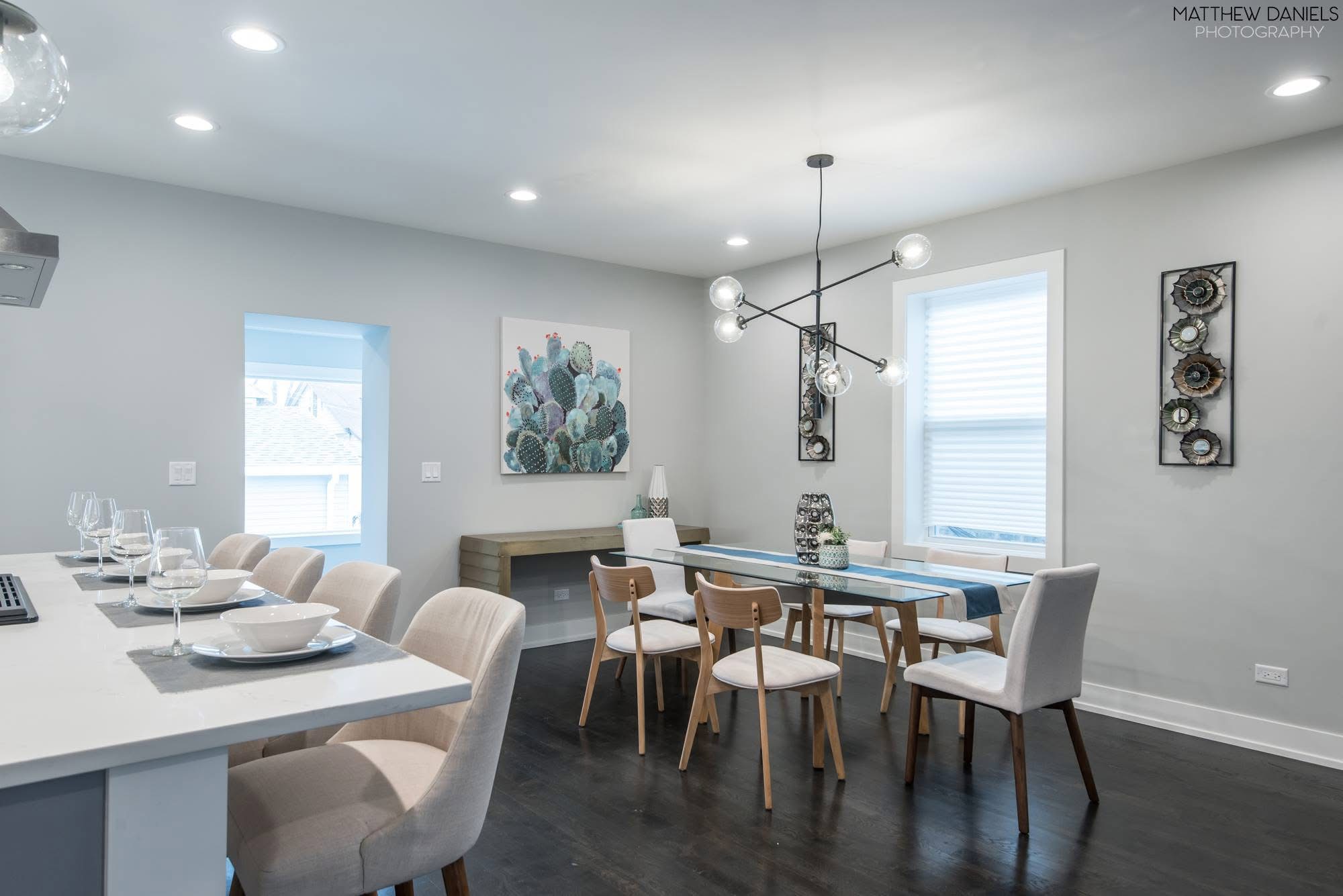 Modern dining room with chandelier and dark hardwood floors