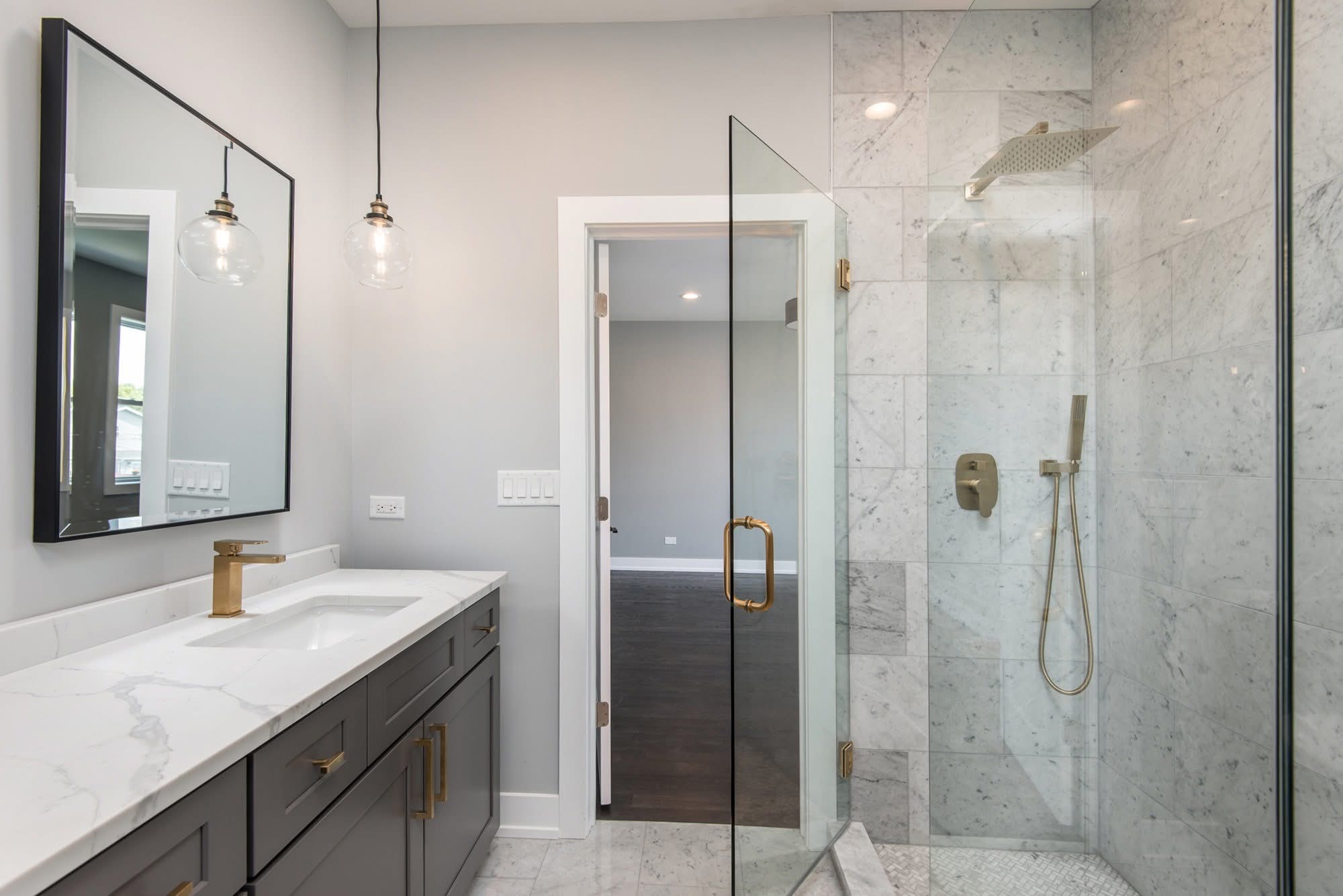 Marble walk-in shower with brass fixtures