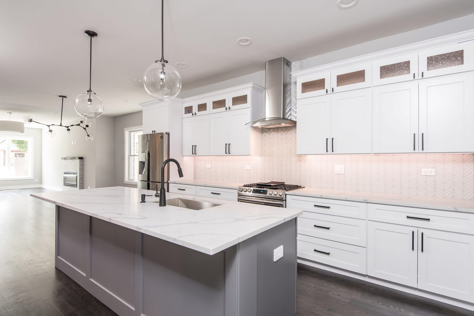 Waterfall island kitchen with chevron backsplash