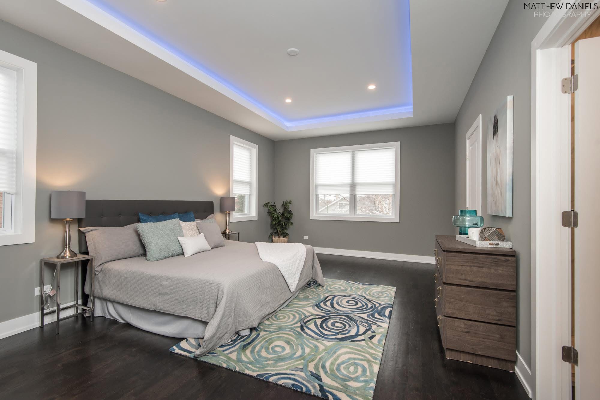 Primary bedroom with tray ceiling and accent lighting
